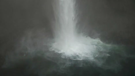 the bottom of snoqualmie falls on a misty morning in autumn in slow motion