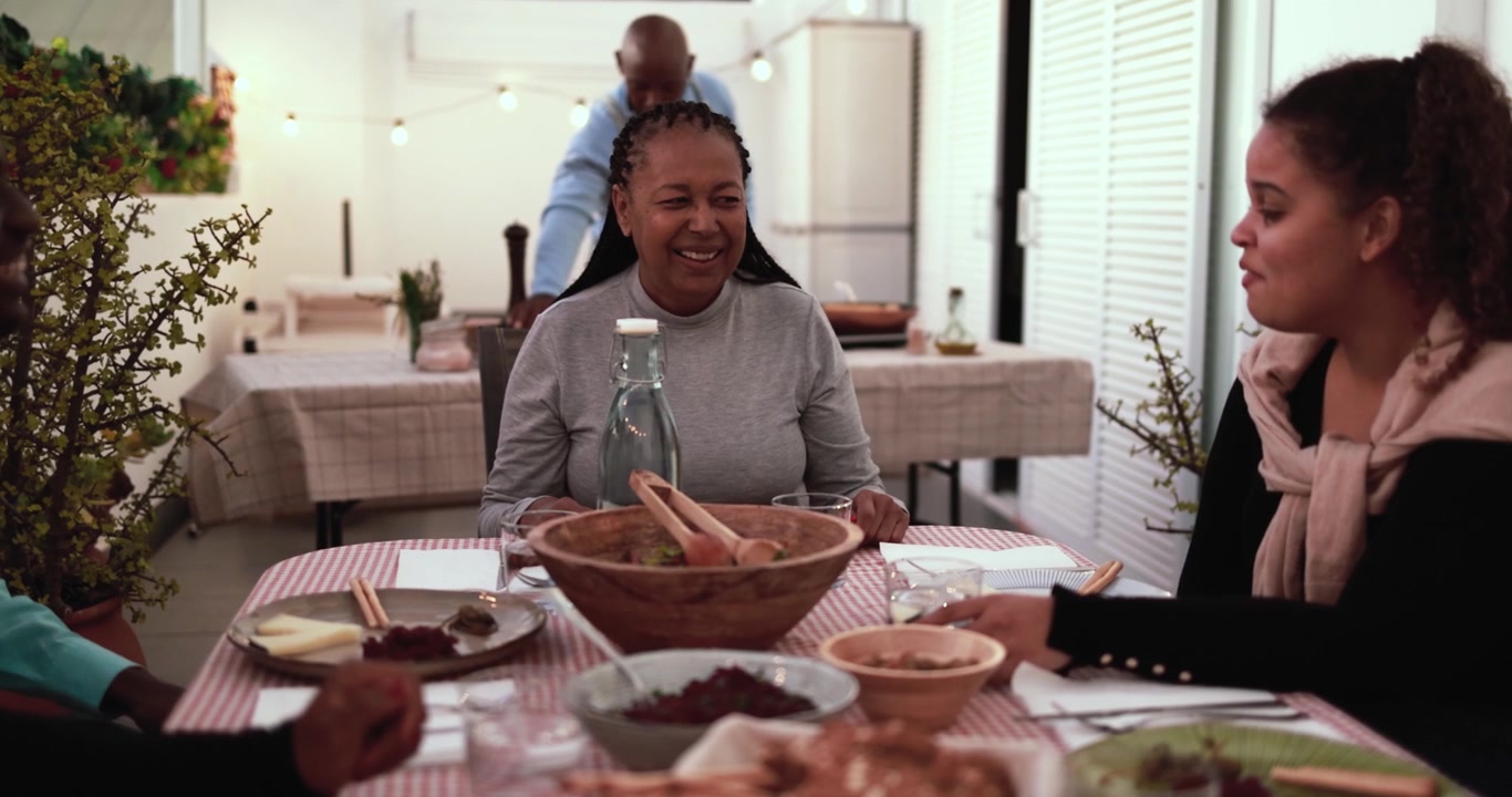 Happy African American Family Enjoying Dinner Together at Home