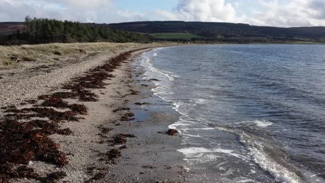 AERIAL---Low-flying-over-Point-Sands-beach,-Mull-of-Kintyre,-Scotland,-forward