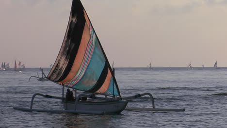 a catamaranstyle fishing boat comes into shore 1