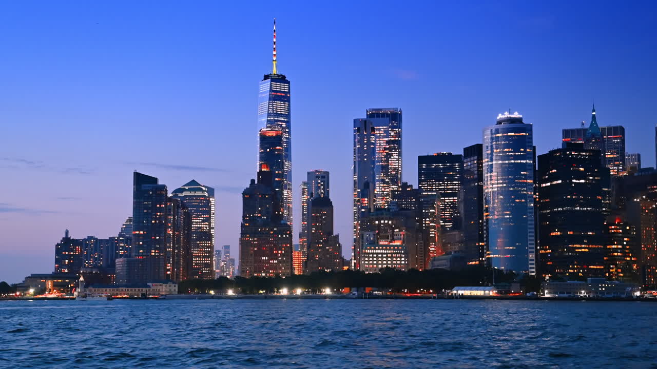 Splendido skyline luminoso di New York al crepuscolo. Vista dal basso sui meravigliosi grattacieli e sui palazzi a partire dal paesaggio fluviale.