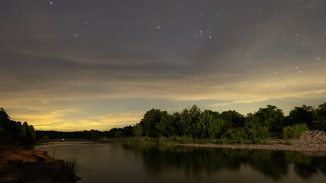 Timelapse-of-the-Milky-Way-core-behind-clouds-and-light-pollution-over-the-Llano-River-outside-of-Mason,-Texas-in-the-Texas-Hill-Country