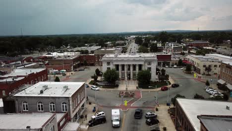 Aerial-of-Alamance-County-Courthouse-in-Graham-NC-as-Ambulance-passes-by-below