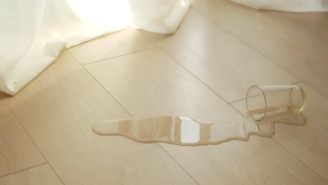 spilled drink on wooden floor