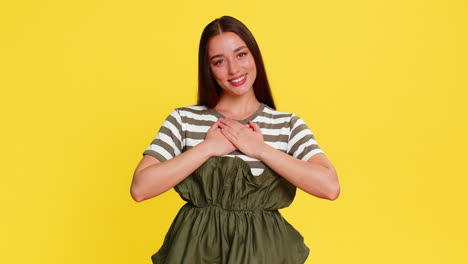 young woman girl holding hands on chest expressing deep gratitude thankful emotional reaction