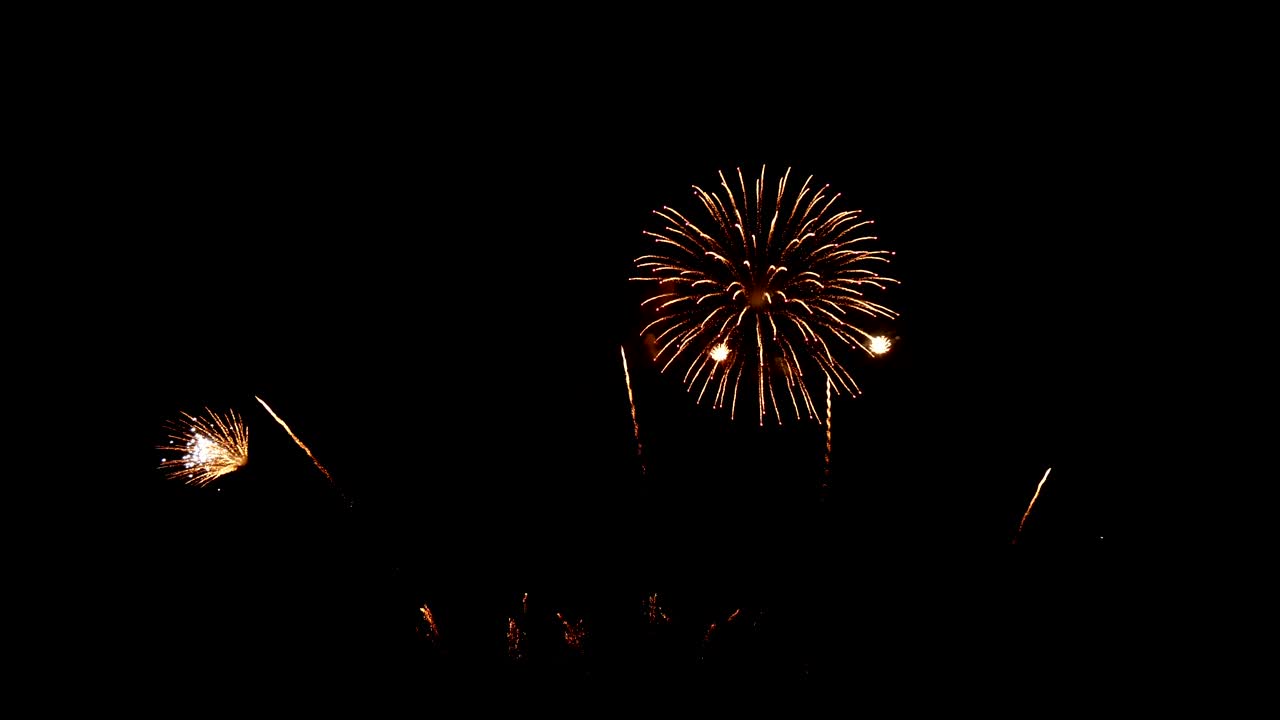 4K. loop seamless of real golden fireworks festival in the sky display at night during national holiday, new year party or celebration event