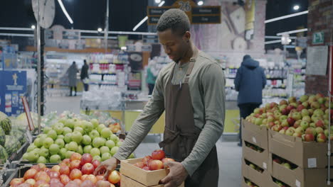 grocery store employee handling apples
