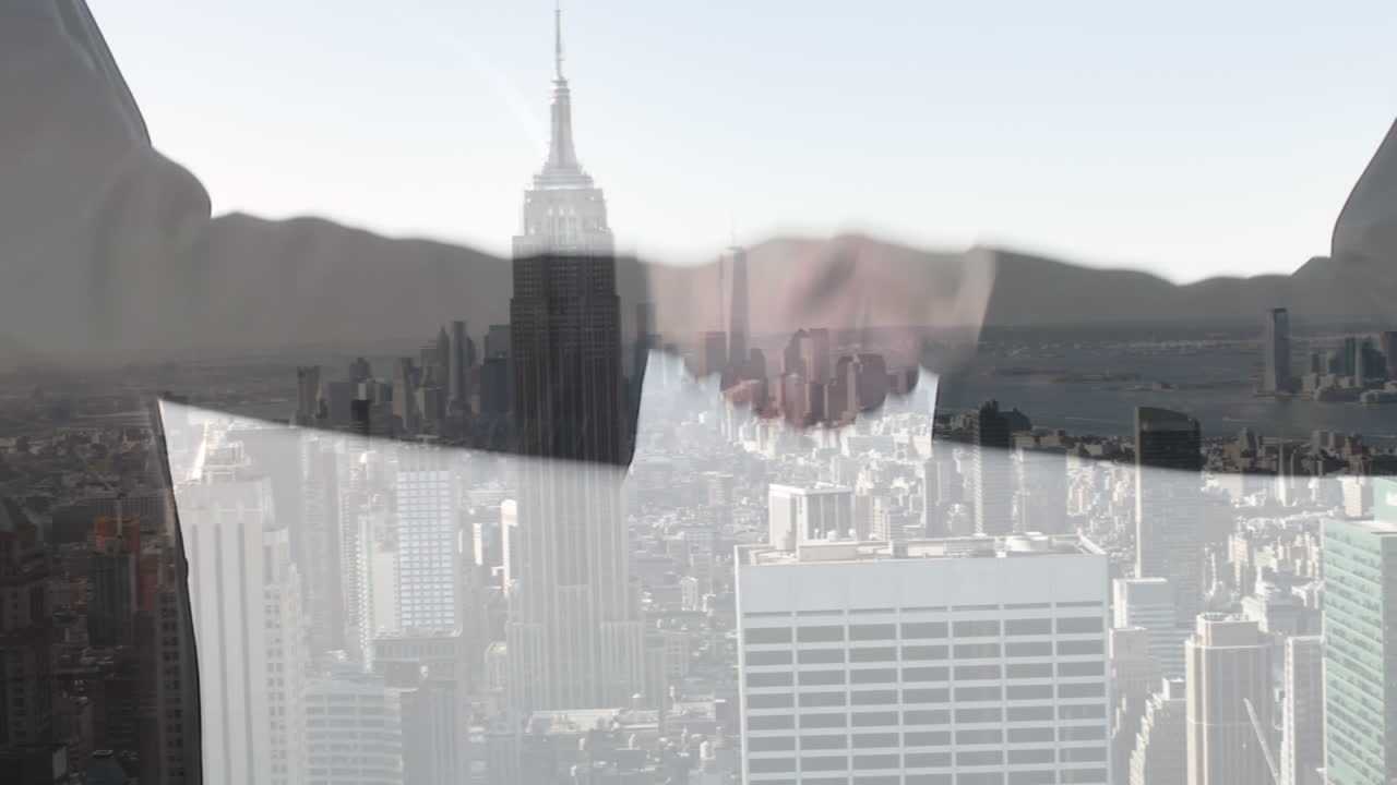 Animation of cityscape over business people shaking hands