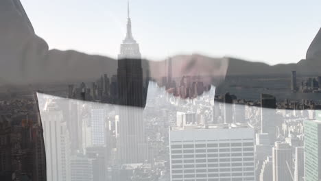 animation of cityscape over business people shaking hands
