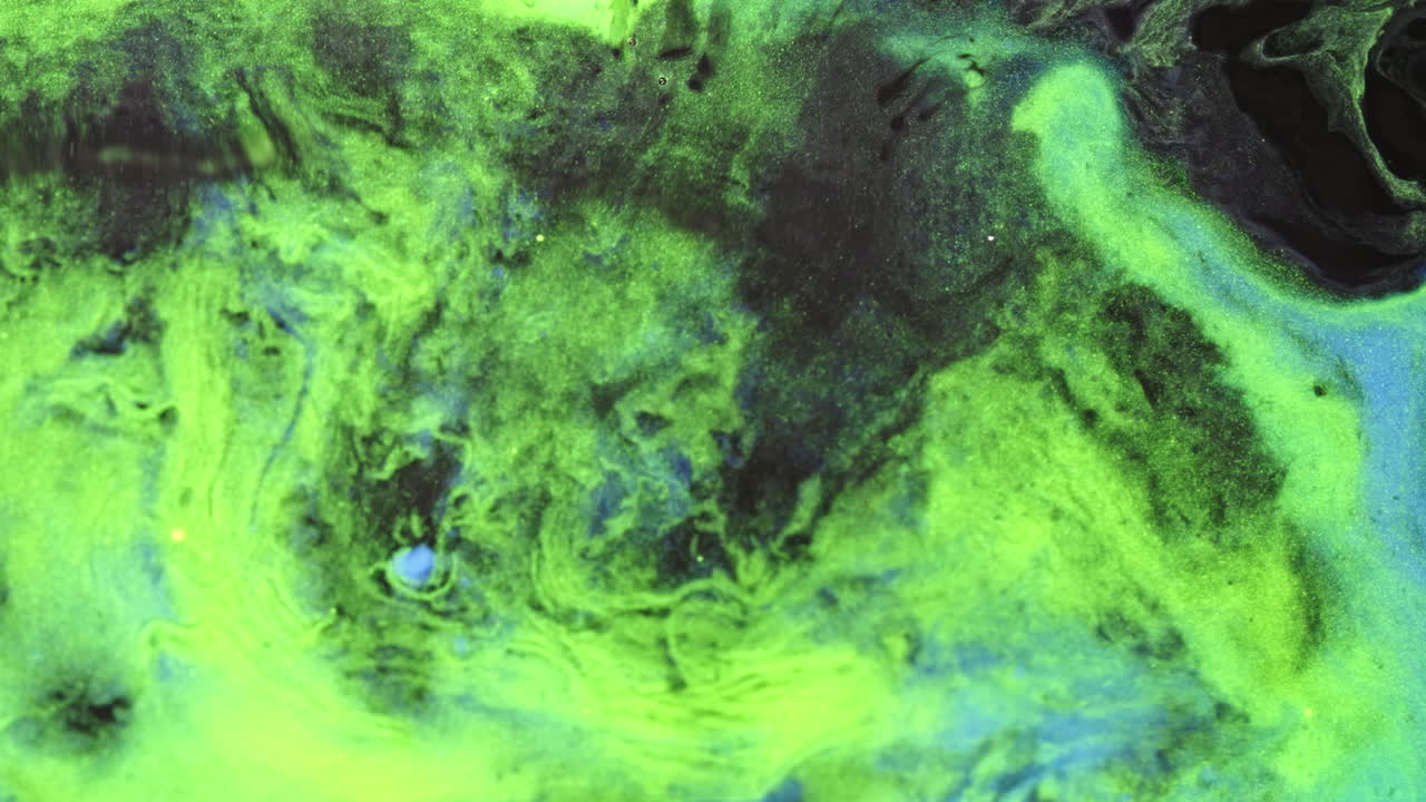 Fluorescent green and black liquid swirl in abstract macro with smooth mixing motion