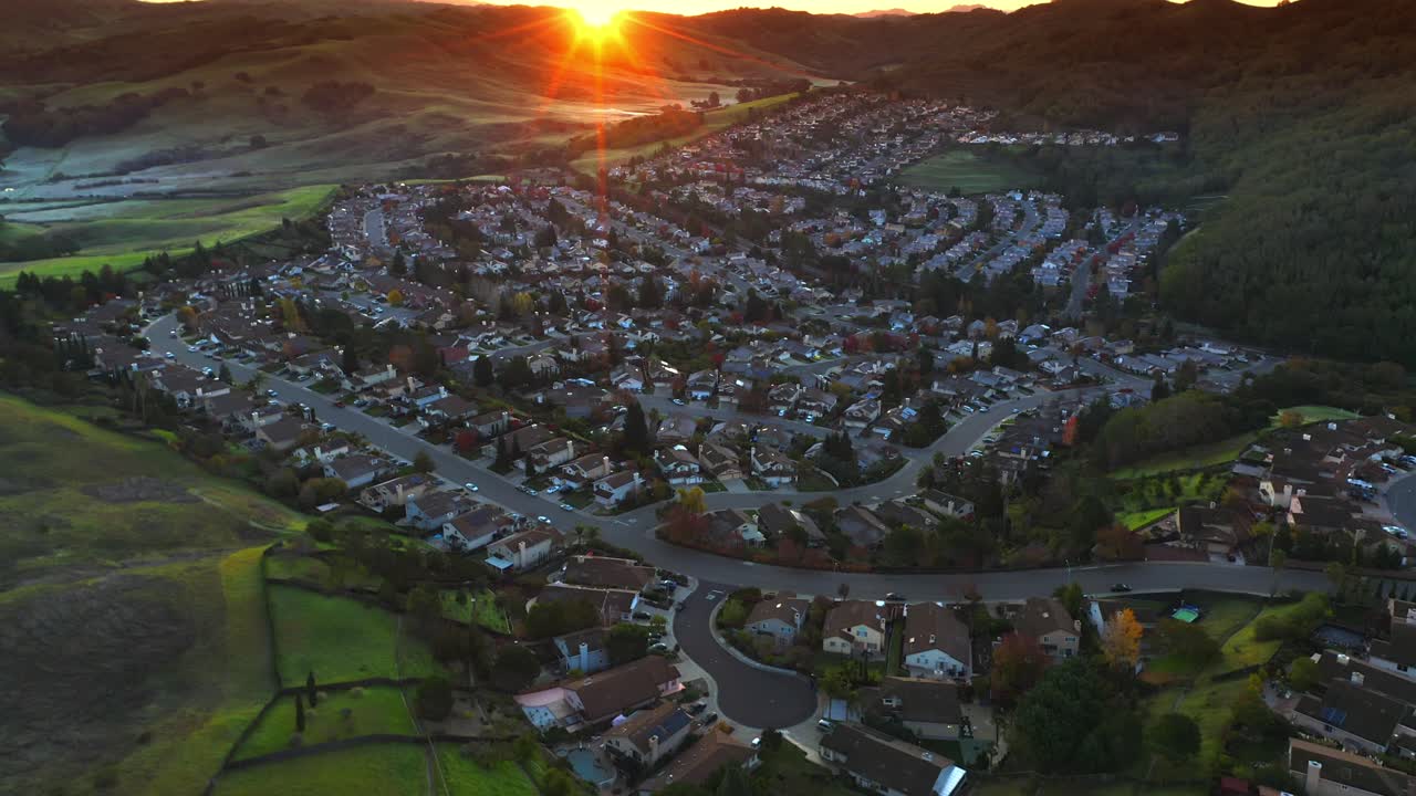 Drone shot over Suburban California neighborhood in between hills.