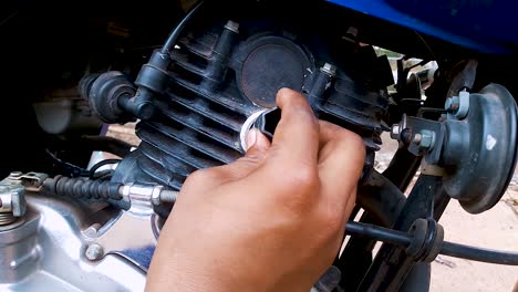 two-wheeler-motorbike-maintenance-at-day-from-flat-angle-in-details