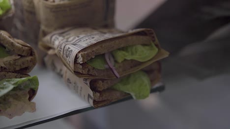 Vegan-sandwich-with-lettuce,-onion-and-brown-bread-in-a-healthy-cafe