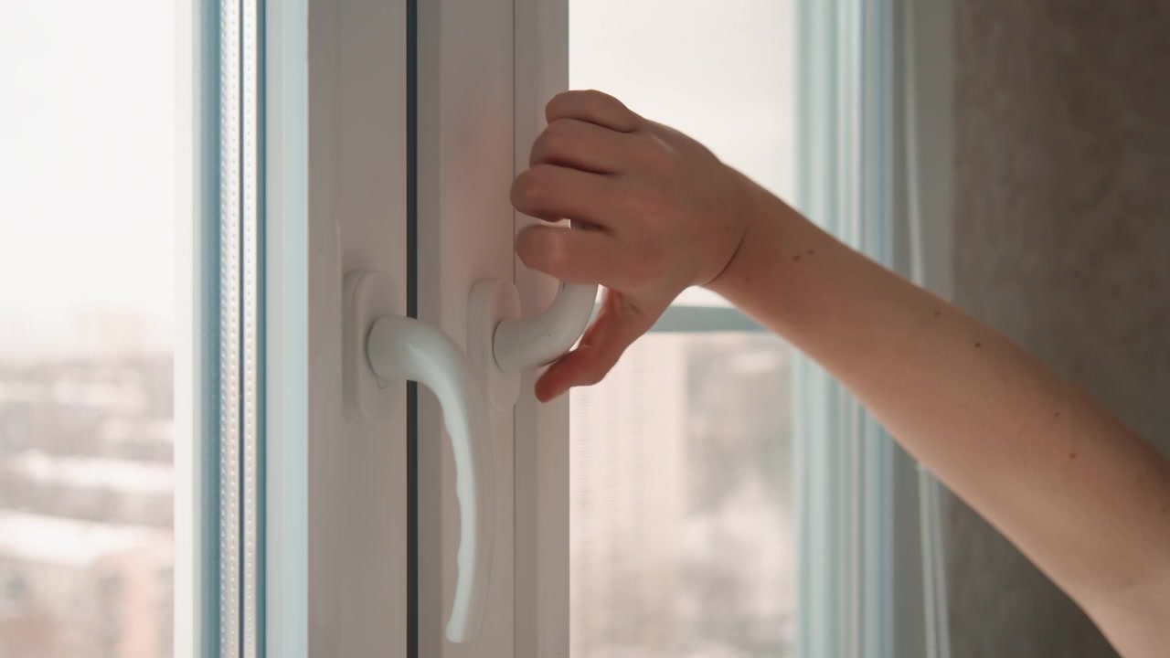 Brushing breeze through open window. Moment of tranquility with fresh air. Peaceful scene with gentle wind and city view. Calming moment as fresh air enters and city skyline appears outside