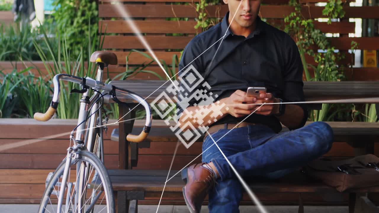 Animation of qr code over biracial man using smartphone