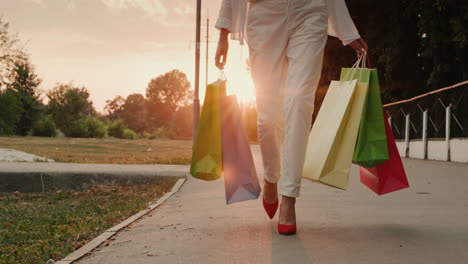 a woman in red shoes carries shopping bags 1