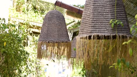 wicker decorations, like lanterns, swaying in the summer breeze