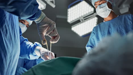 Doctors,-team-and-scissors-in-theater-for-surgery
