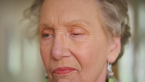 Elderly-woman-thinking,-real-sad-tired-blue-eyes