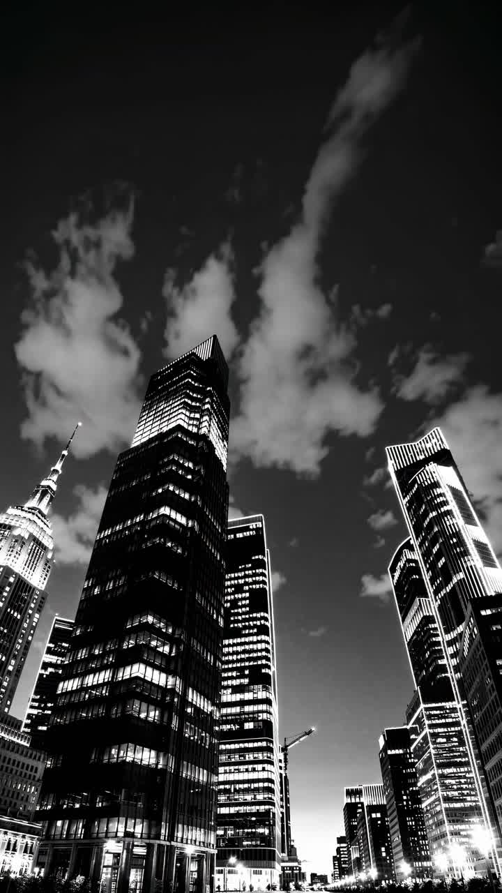 Black and white cityscape with towering skyscrapers, captured from a low-angle