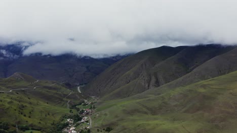 mountain valley with clouds and winding road