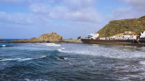 waves hitting a beach and rocks,harbor town,tenerife,canary islands,spain.