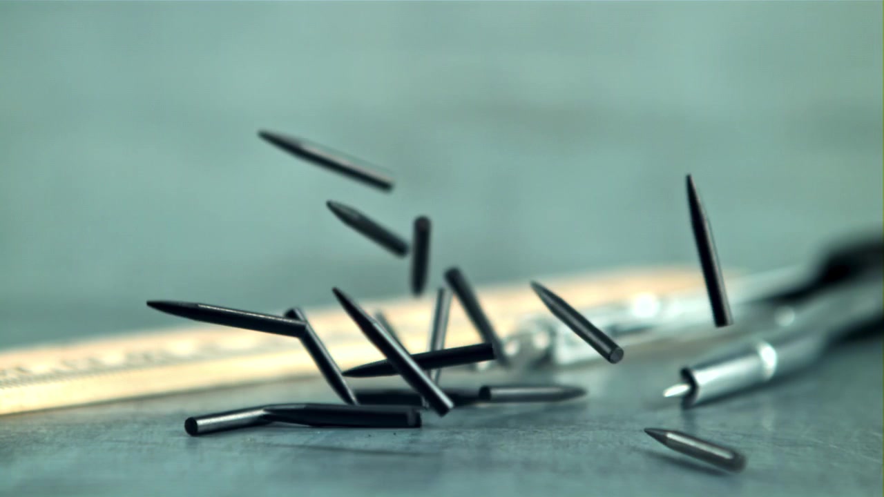 Graphite Pencil Leads Falling in Slow Motion on a Desk