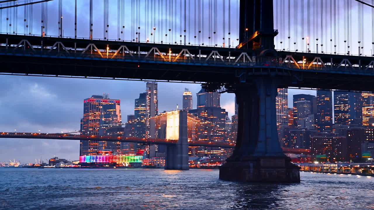 East River tour at dusk time. Footage near the Manhattan Bridge. The Brooklyn Bridge and New York skyline at backdrop