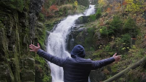 male tourist a sense of freedom in nature mountain waterfall male tourist a sense of freedom in nature mountain waterfall