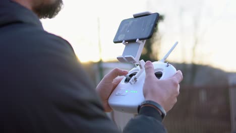 person operating a drone with remote control