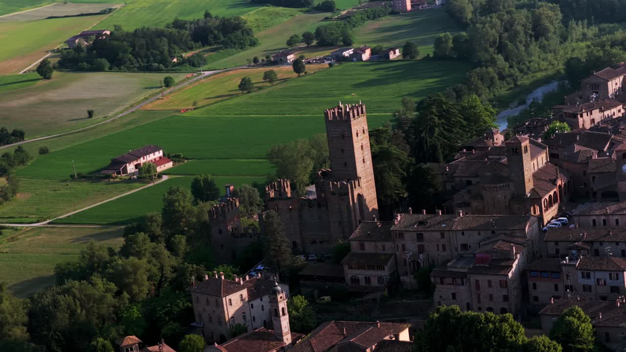 Castell'Arquato, historic medieval village and castle, surrounded by green countryside in Emilia-Romagna, Italy. Aerial drone orbiting