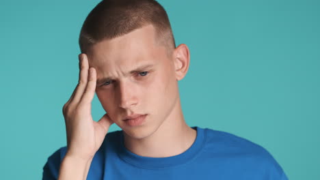 sad young man with headache