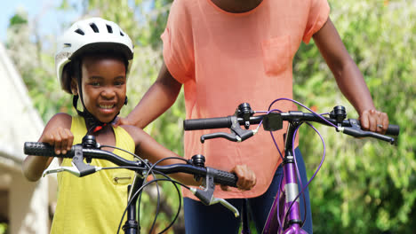woman learning to his daughter to go cycling