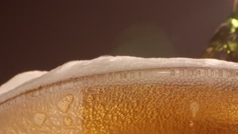 beer with foam spilling over glass