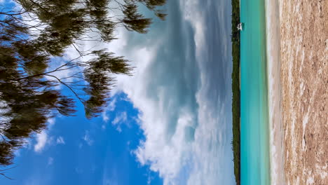 vertical format timelapse of anchored boat in beautiful kuto bay, isle of pines