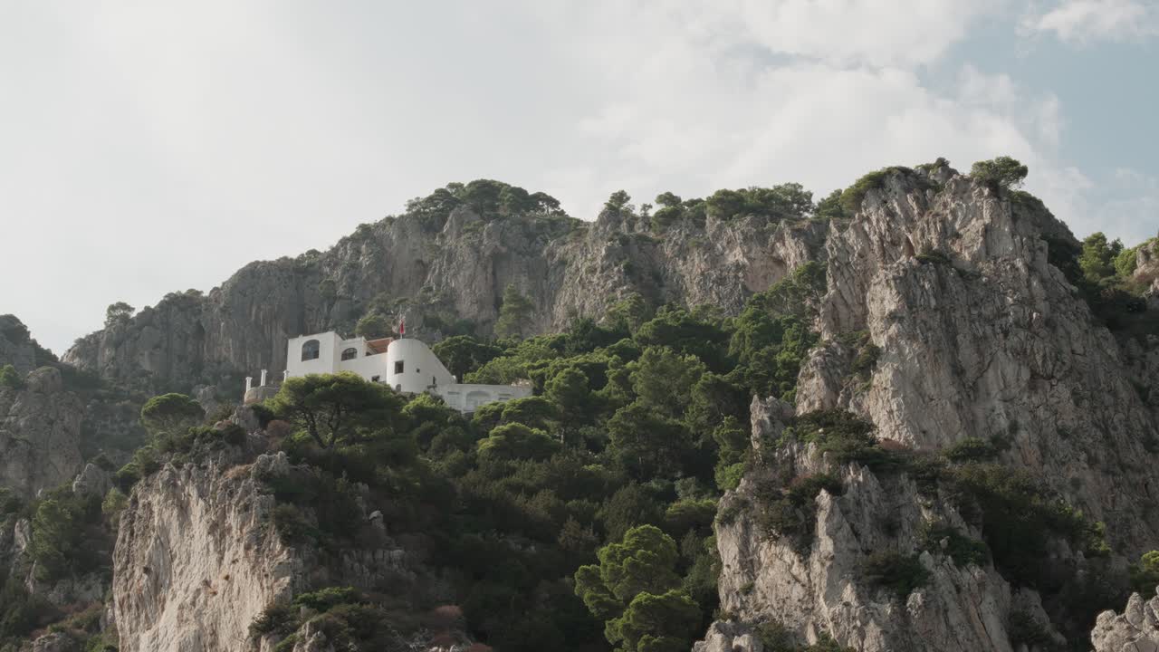 A view of the cliffside villas while sailing across the waters of Capri in Italy.