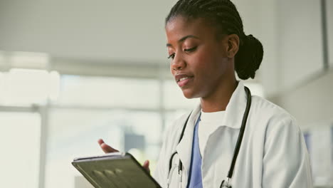 doctor reviewing medical records on tablet