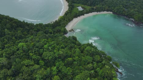 aerial drone flyover manuel antonio tropical beach shoreline, costa rica 4k