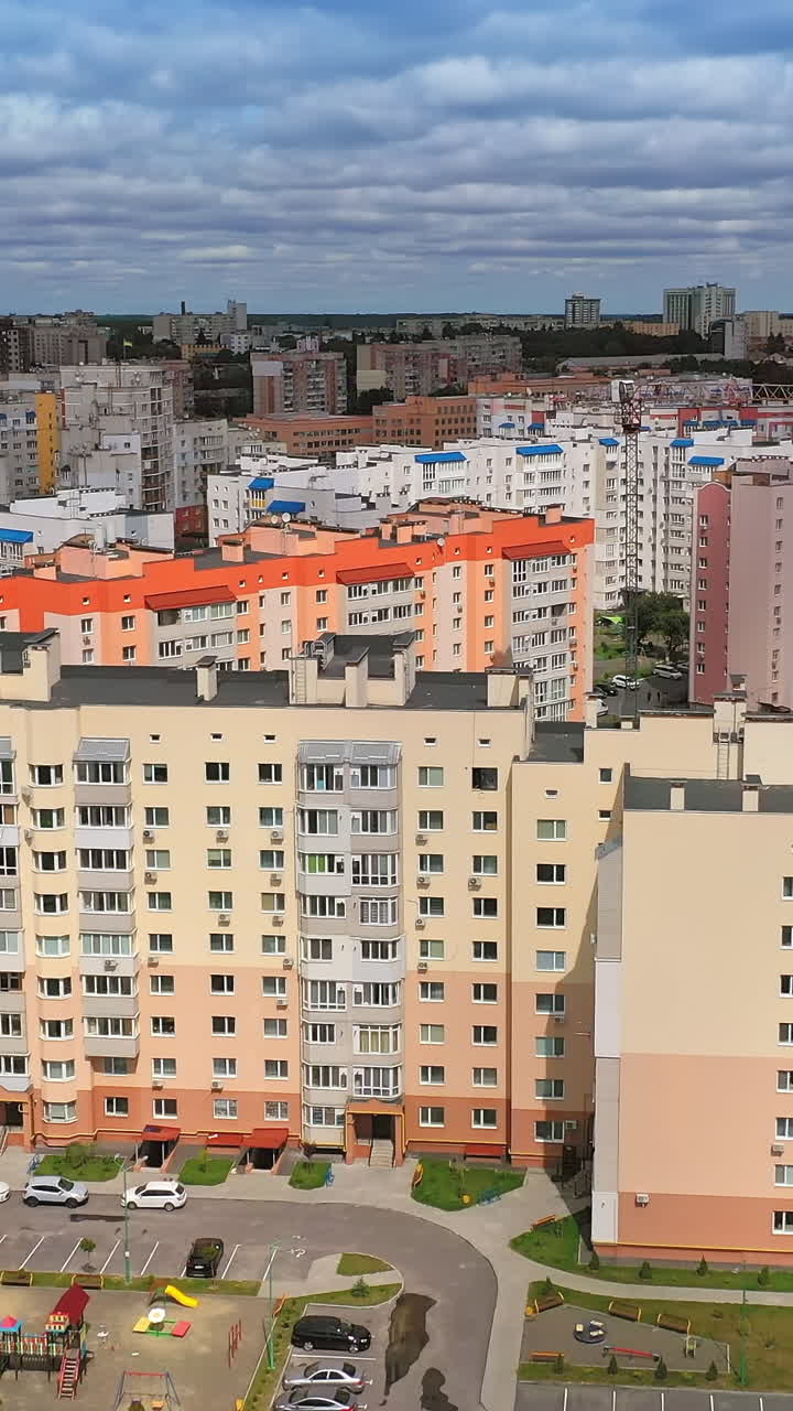 New residential area in the city. Modern apartment buildings for residents in new district. Construction of contemporary architecture. Aerial flight. Vertical video