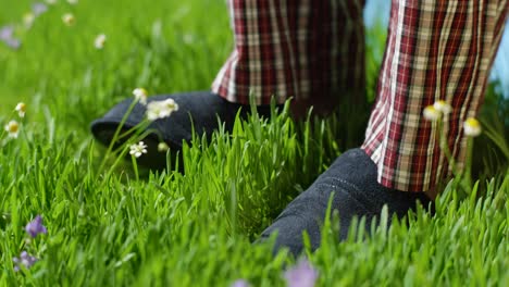 persona en pijama y zapatillas de pie en el césped