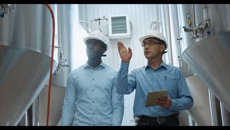 engineers discussing operations in a brewery