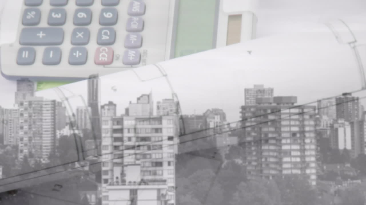 테이블 위에 놓여있는 계산기와 여러 블루프린트의 애니메이션, 도시 풍경 위에서 회전