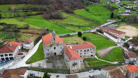 tilt down to monastery in lush green village of spain