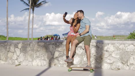 Excited-couple-taking-selfie-on-seafront
