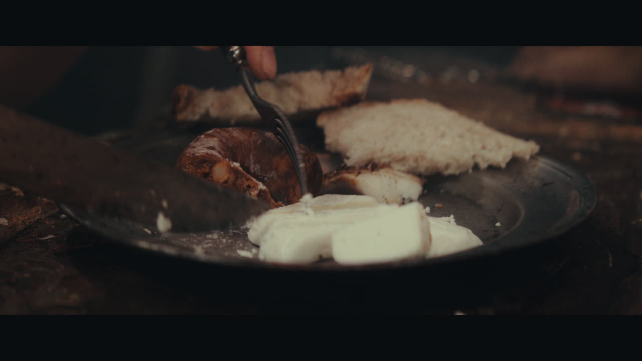 An old pirate eats and drinks inside the sailing ship cabin