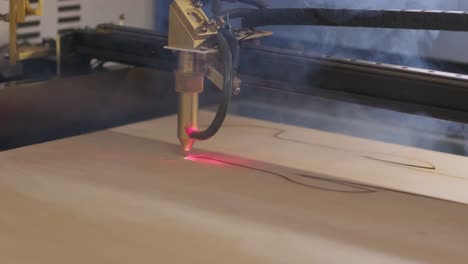 cnc laser cutting machine cuts wooden plank and plywood