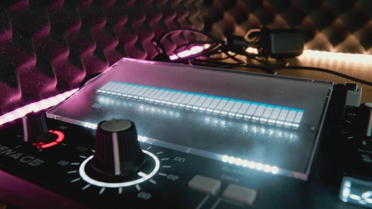 Displaying mixer powering on, showing equalizer bars and lit knob indicating levels on home desk