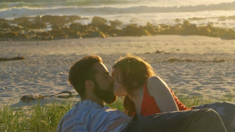 beautiful romantic couple lying down and kissing on the beach 4k