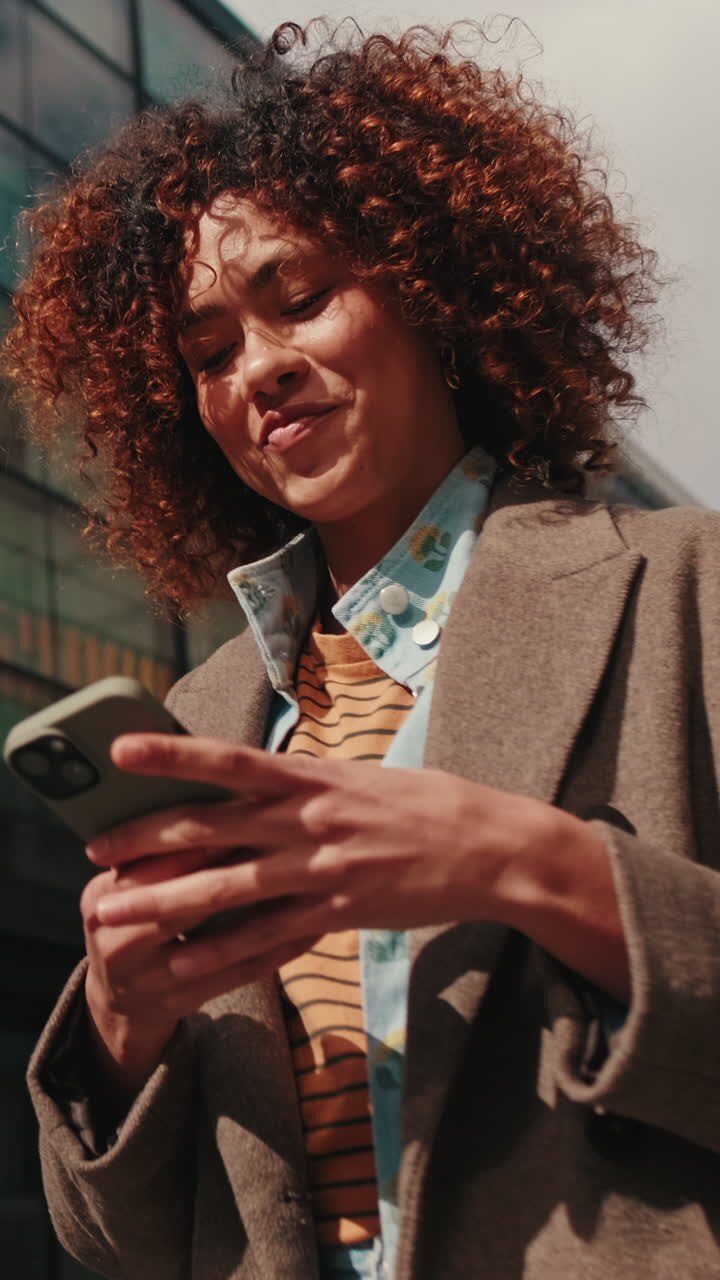 Happy Businesswoman Walks While Using Smartphone