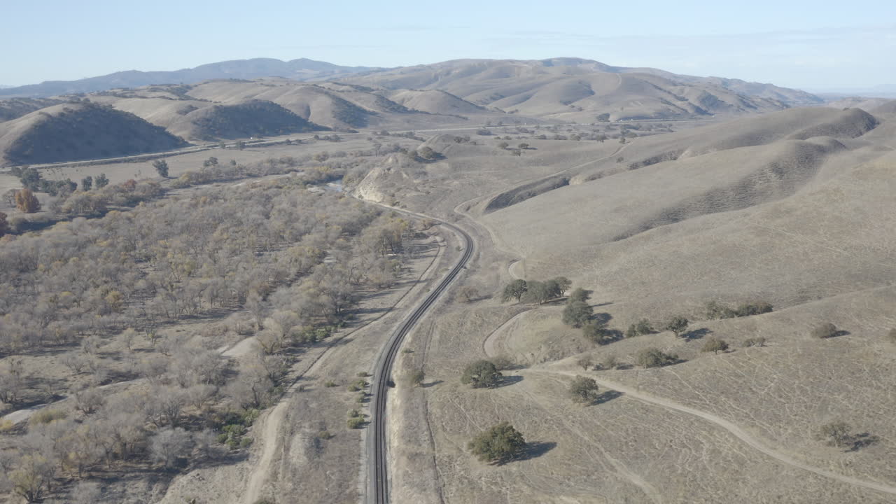 4K aerial of the Salinas River, train tracks and the 101 freeway near the town of Bradley in central California.